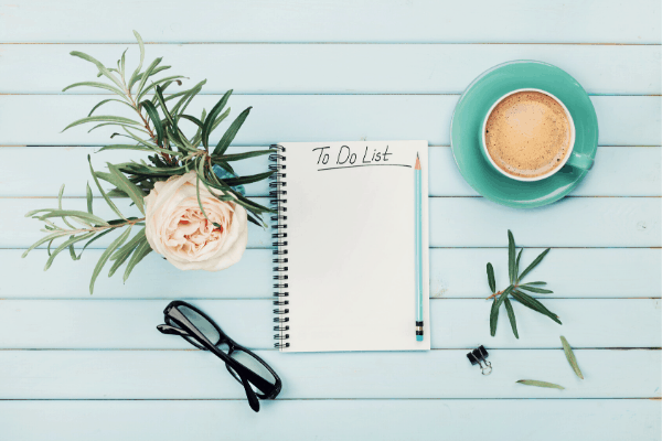 to do list - pad of paper on table with flower and coffee